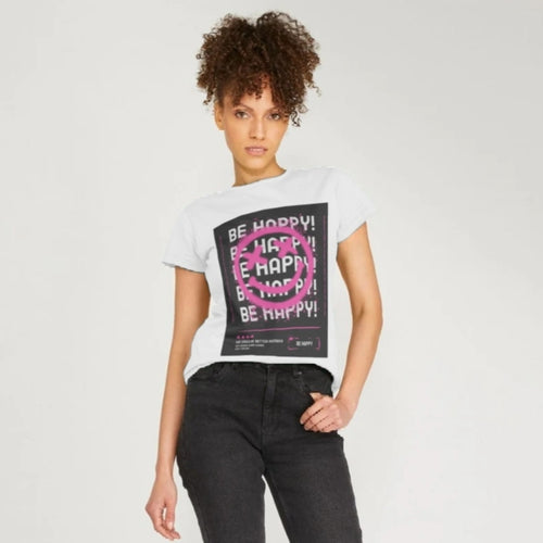 Young Woman wearing a white t shirt with Be Happy graphics on it and pink smiley face. From a collection by Pink Runway.